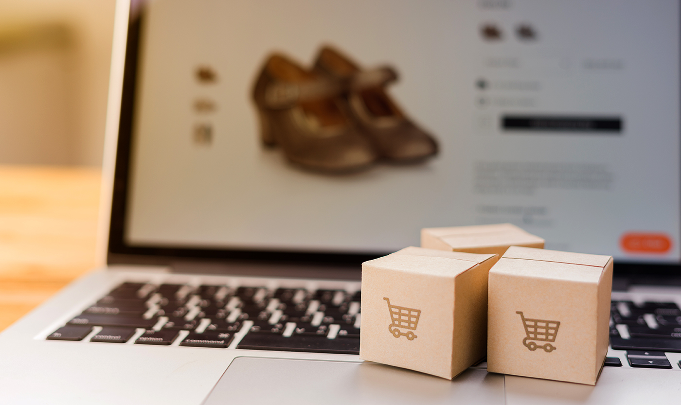 Laptop With Three Small Boxes Shopping Cart logo