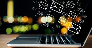 Laptop with emails coming out of it