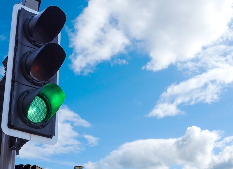Verve News Articles Traffic light against blue sky - lights on green