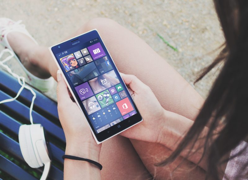 Verve News Articles Woman sitting looking at mobile phone