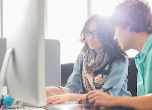 Verve News Articles Two people working at a computer