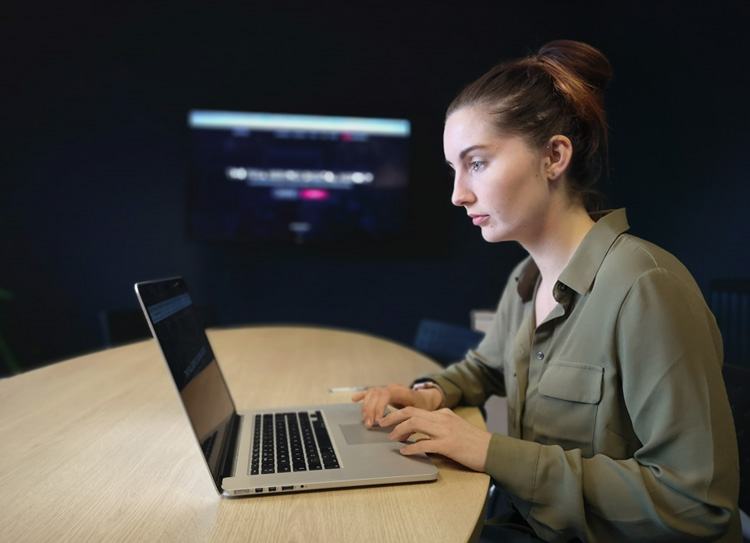 Lady sitting at desk with laptop in front