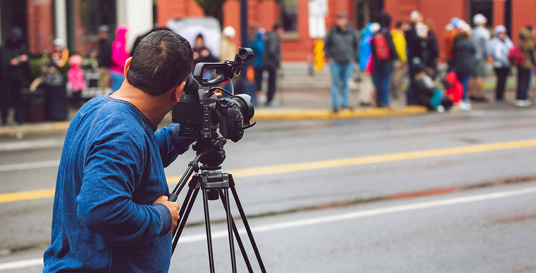 Man with video camera filming