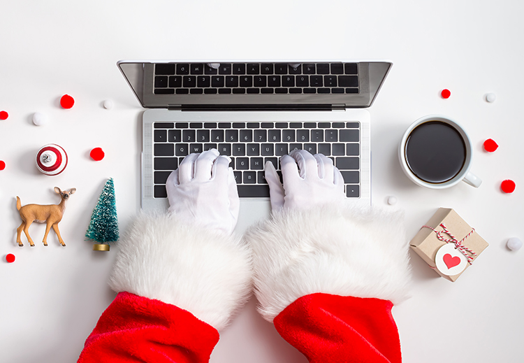 Santa hands typing on laptop