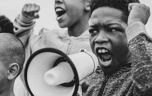 Young boy shouting through megaphone