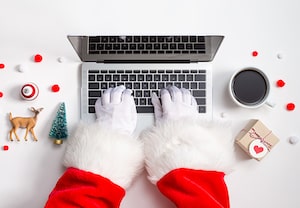 Santa hands typing on laptop