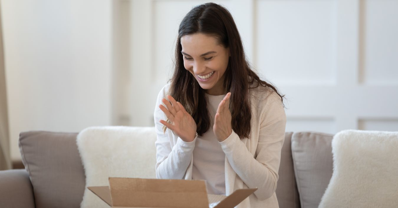 Happy Person Smiling While Opening a Delivery